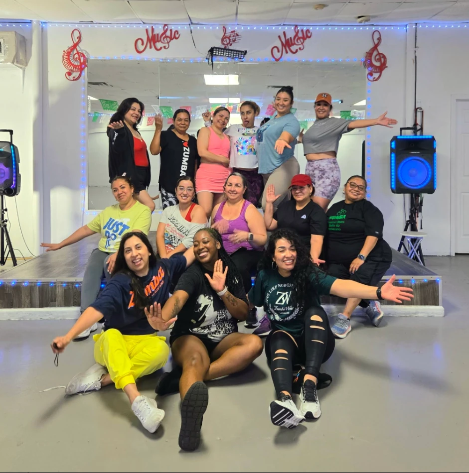 Macarena's members posing in front of the studio stage